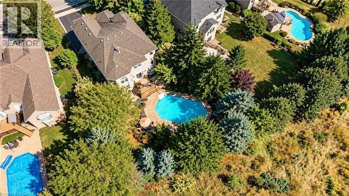 Property featuring an inground swimming pool, expansive rear deck, and mature landscaping - 74 Davidson Boulevard, Dundas, ON 