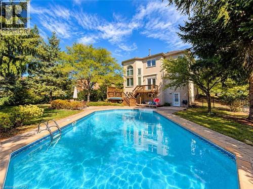 Rectangular in-ground pool with a stone paver surround - 74 Davidson Boulevard, Dundas, ON 