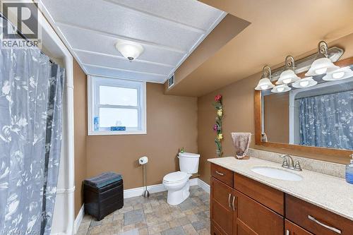 Functional bathroom featuring a shower enclosure, vanity with integrated sink, and vanity mirror - 34 Wayne Drive, Kitchener, ON 