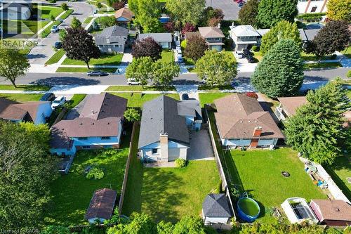 Residential street with paved roadways and sidewalks, surrounded by mature trees and manicured lawns - 34 Wayne Drive, Kitchener, ON 