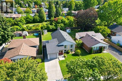 Aerial perspective showcasing a residential property with a sloped roof, an attached garage, a paved driveway, and a manicured lawn - 34 Wayne Drive, Kitchener, ON 