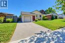 Lovely curb appeal featuring a single-car garage, concrete driveway, and a red entry door - 34 Wayne Drive, Kitchener, ON 
