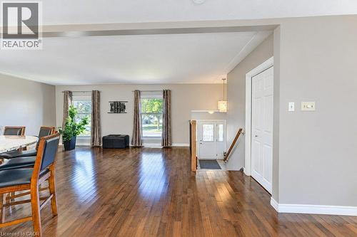 Hardwood flooring throughout, multiple windows, a white paneled entry door, and recessed lighting - 34 Wayne Drive, Kitchener, ON 