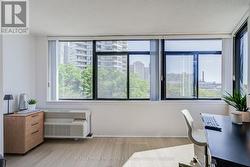 Den with massive east facing windows. - 