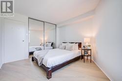 Bedroom with closet and luxury vinyl plank floors. - 