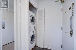 Stacked washer and dryer by entrance door. - 