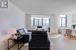 View of living room with den in background. - 
