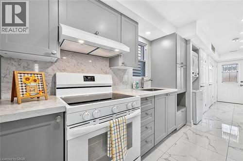 White electric range with an integrated oven, gray shaker-style cabinetry, and light-toned countertops - 4 Albemarle Street, Hamilton, ON 