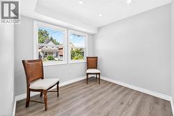 Recessed lighting, wood-finish flooring, white trim, and two windows - 
