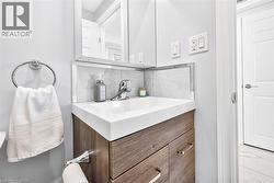 Wood-finish vanity with integrated sink, chrome faucet, and mirrored medicine cabinet - 