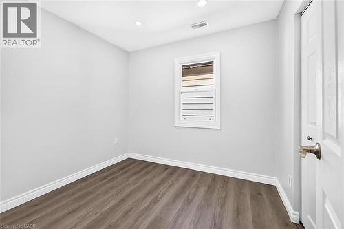Recessed ceiling lighting, wood-finish flooring, white window trim, and a paneled interior door - 4 Albemarle Street, Hamilton, ON 