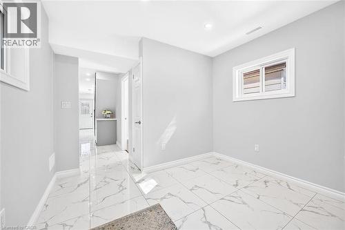 White-framed windows, recessed lighting, white baseboards, and light-toned walls - 4 Albemarle Street, Hamilton, ON 