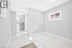 White-framed windows, recessed lighting, white baseboards, and light-toned walls - 