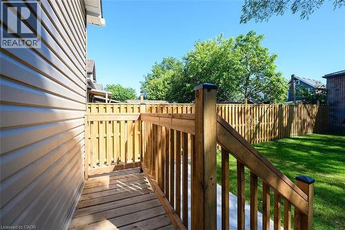 Outdoor deck with wood railing, leading to a private backyard - 4 Albemarle Street, Hamilton, ON 