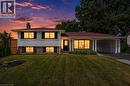 Split-level home featuring white siding, dark brick accents, and a red shingle roof - 299 Dale Crescent, Waterloo, ON 