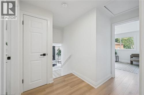 Bright hallway featuring light wood-finish flooring and white baseboards - 299 Dale Crescent, Waterloo, ON 