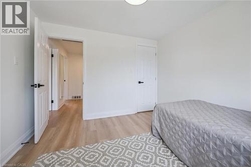 Bright room featuring light wood-finish flooring, white walls, and white trim - 299 Dale Crescent, Waterloo, ON 