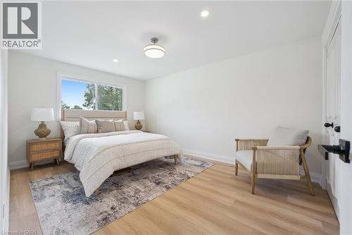 Bright interior space featuring light wood-finish flooring, white walls, and a window with outdoor scenery - 299 Dale Crescent, Waterloo, ON 