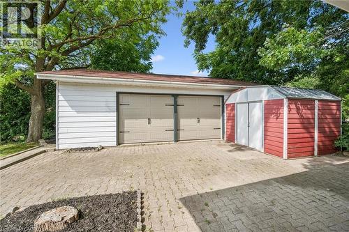 Two-car garage with tan panel doors and white siding - 299 Dale Crescent, Waterloo, ON 