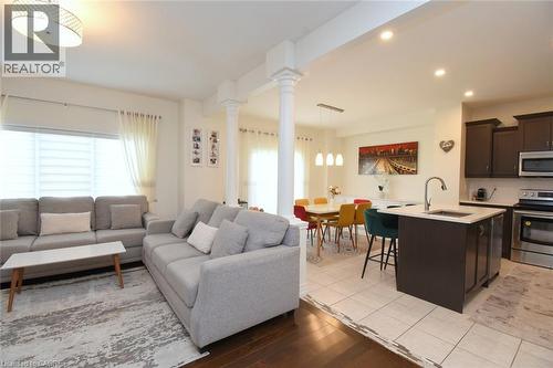 Open concept living space with recessed lighting, wood-finish flooring, and white interior columns - 25 Guest Street, Hamilton, ON 