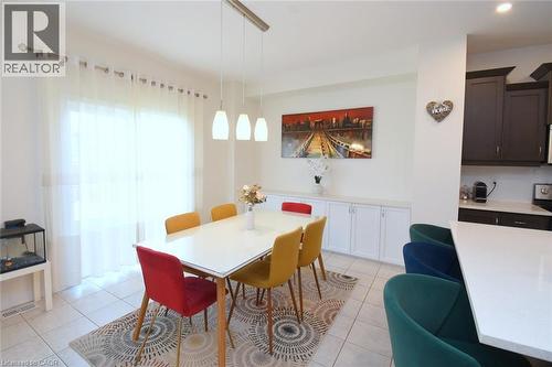 Recessed lighting, tile flooring, built-in cabinetry with a white countertop, and a sliding glass door - 25 Guest Street, Hamilton, ON 