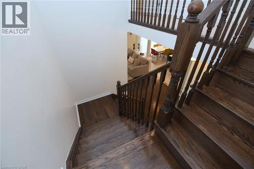 Hardwood staircase with dark wood-finish treads and balusters - 25 Guest Street, Hamilton, ON 