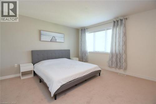 Neutral wall tones, window with horizontal blinds, and light-toned carpeting - 25 Guest Street, Hamilton, ON 
