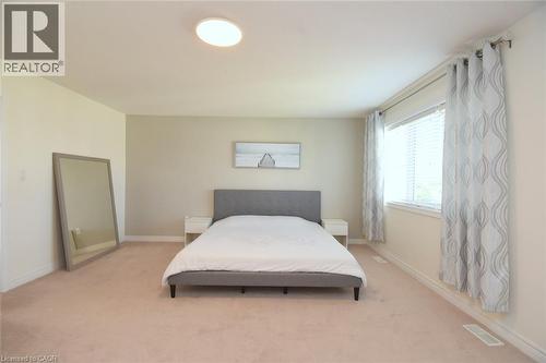 Spacious room with plush carpeting, a large window, and recessed ceiling lighting - 25 Guest Street, Hamilton, ON 