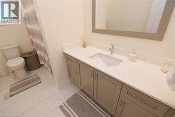 Single vanity with a light countertop, integrated sink, chrome faucet, and cabinet storage - 