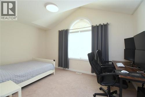 Vaulted ceiling with an arched window, round ceiling light fixture, and neutral carpeting - 25 Guest Street, Hamilton, ON 
