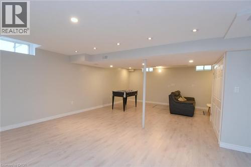 Recessed lighting, light wood-finish flooring, white trim, and a window - 25 Guest Street, Hamilton, ON 