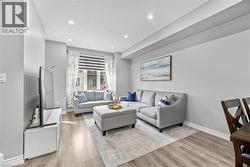 Recessed lighting, wood-finish flooring, and white trim - 