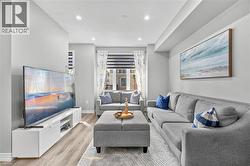 Recessed ceiling lighting, wood-finish flooring, and light gray wall paint - 