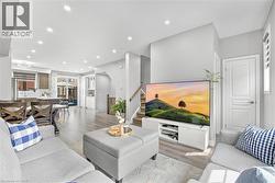 Open-concept living area with recessed lighting, wood-finish flooring, and light gray wall tones - 