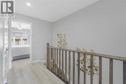 Wood-finish flooring throughout the hallway - 