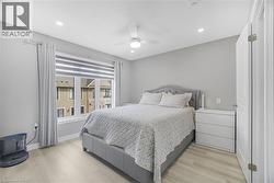 Recessed lighting, ceiling fan, wood-finish flooring, and a window with blinds - 