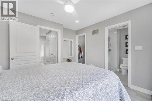 Recessed lighting, ceiling fan with integrated light, a walk-in closet, and a three-piece bathroom with a glass-enclosed shower - 1890 Rymal Road E Unit# 144, Hamilton, ON 