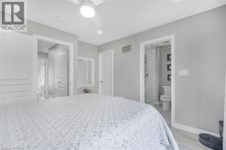 Recessed lighting, ceiling fan, wood-finish flooring, white trim, and a full bathroom with a walk-in shower - 