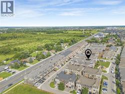 Aerial perspective showcasing a residential community with townhomes and detached properties - 