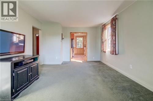 Carpeted flooring throughout, light-toned walls, and a window with curtains - 174 Bridgeport Road E, Waterloo, ON 