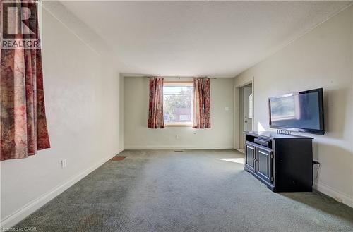 Light-colored walls, broad windows, and carpeted flooring - 174 Bridgeport Road E, Waterloo, ON 