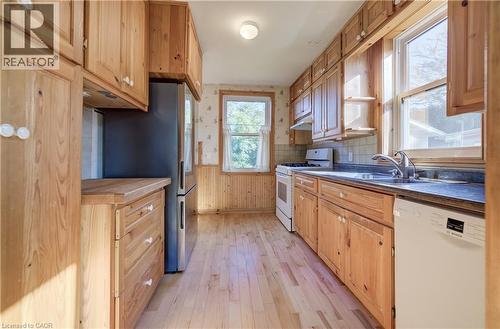 Kitchen featuring extensive wood cabinetry, wood-finish flooring - 174 Bridgeport Road E, Waterloo, ON 