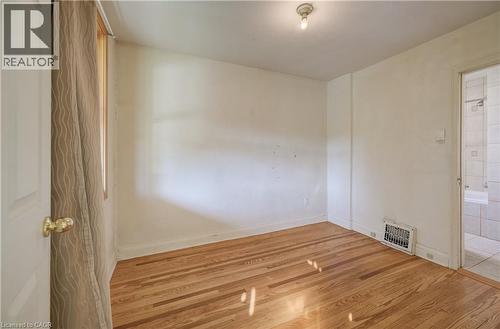 Wood-finish flooring with a ceiling-mounted light fixture - 174 Bridgeport Road E, Waterloo, ON 