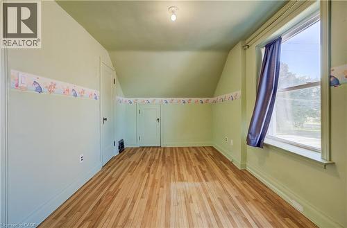 wood-finish flooring, a window with natural light, and a built-in closet with a paneled door - 174 Bridgeport Road E, Waterloo, ON 
