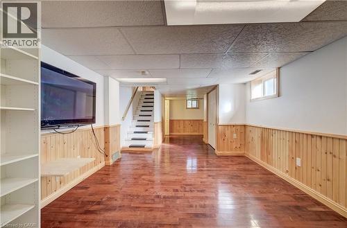 Wood-finish flooring throughout, complemented by wood panel wainscoting - 174 Bridgeport Road E, Waterloo, ON 