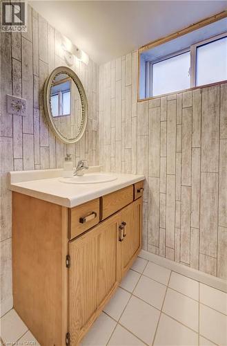 Oak wood-finish vanity with a white countertop and integrated sink - 174 Bridgeport Road E, Waterloo, ON 