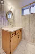 Oak wood-finish vanity with a white countertop and integrated sink - 