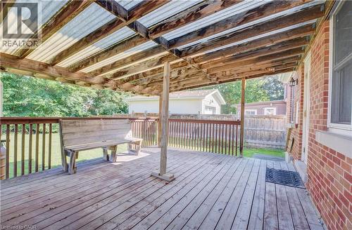 Expansive outdoor deck featuring wood flooring, a wood railing, and a translucent panel roof - 174 Bridgeport Road E, Waterloo, ON 
