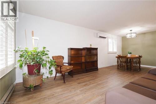 Living room with wall-mounted climate control unit - 219 Foxhunt Road, Waterloo, ON 