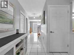 Tiled flooring, white wainscoting, white doors, and a built-in console cabinet - 
